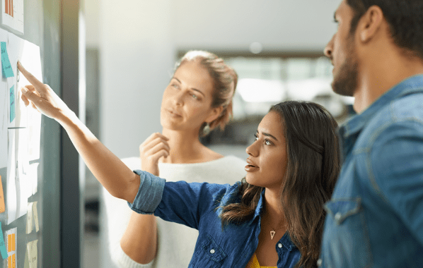 A meeting between colleagues discussing how to kickstart their SAFe agile journey. 
